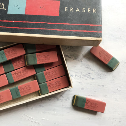 Box of Blue Star erasers with a few on a surface