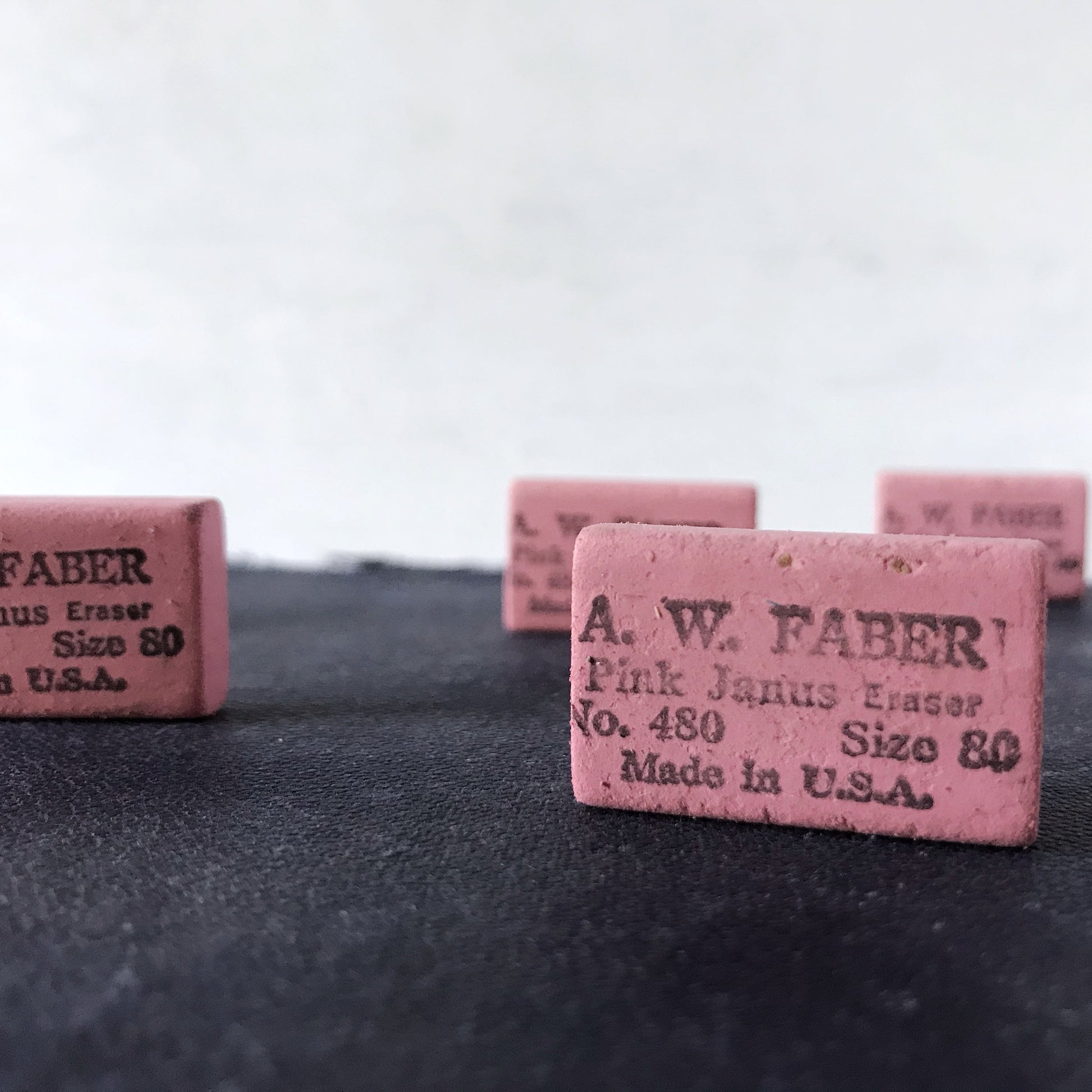 Pink chalk blocks with 'A. W. Faber' branding on a dark surface.