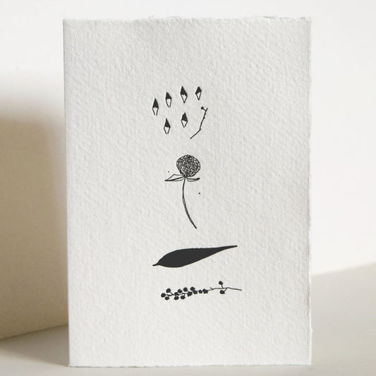 White letterpress card with black floral design on a white background